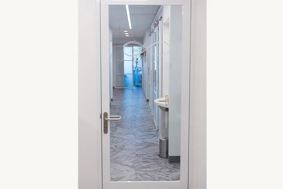 Modern interior door opening to a bright hallway in a facial spa
