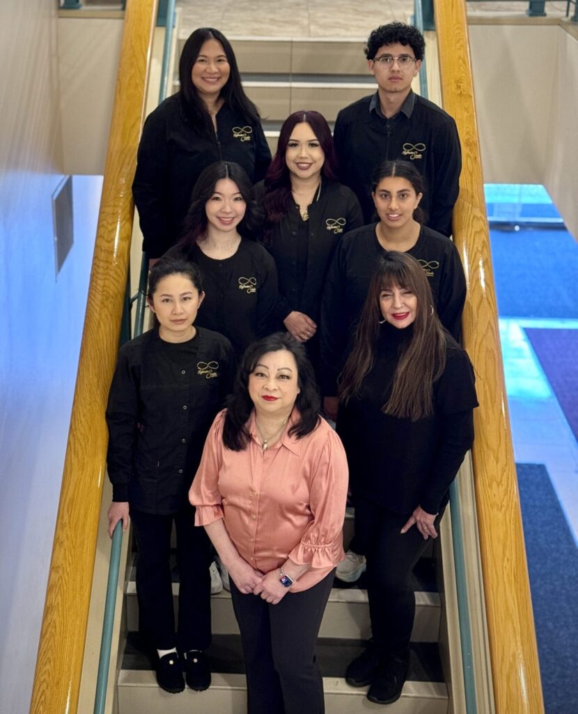 Friendly and professional facial spa team of licensed estheticians smiling inside treatment room