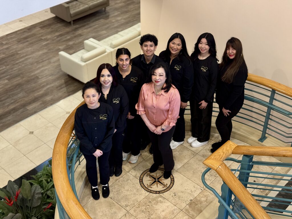 Professional facial spa team smiling inside treatment studio in Pleasanton, CA