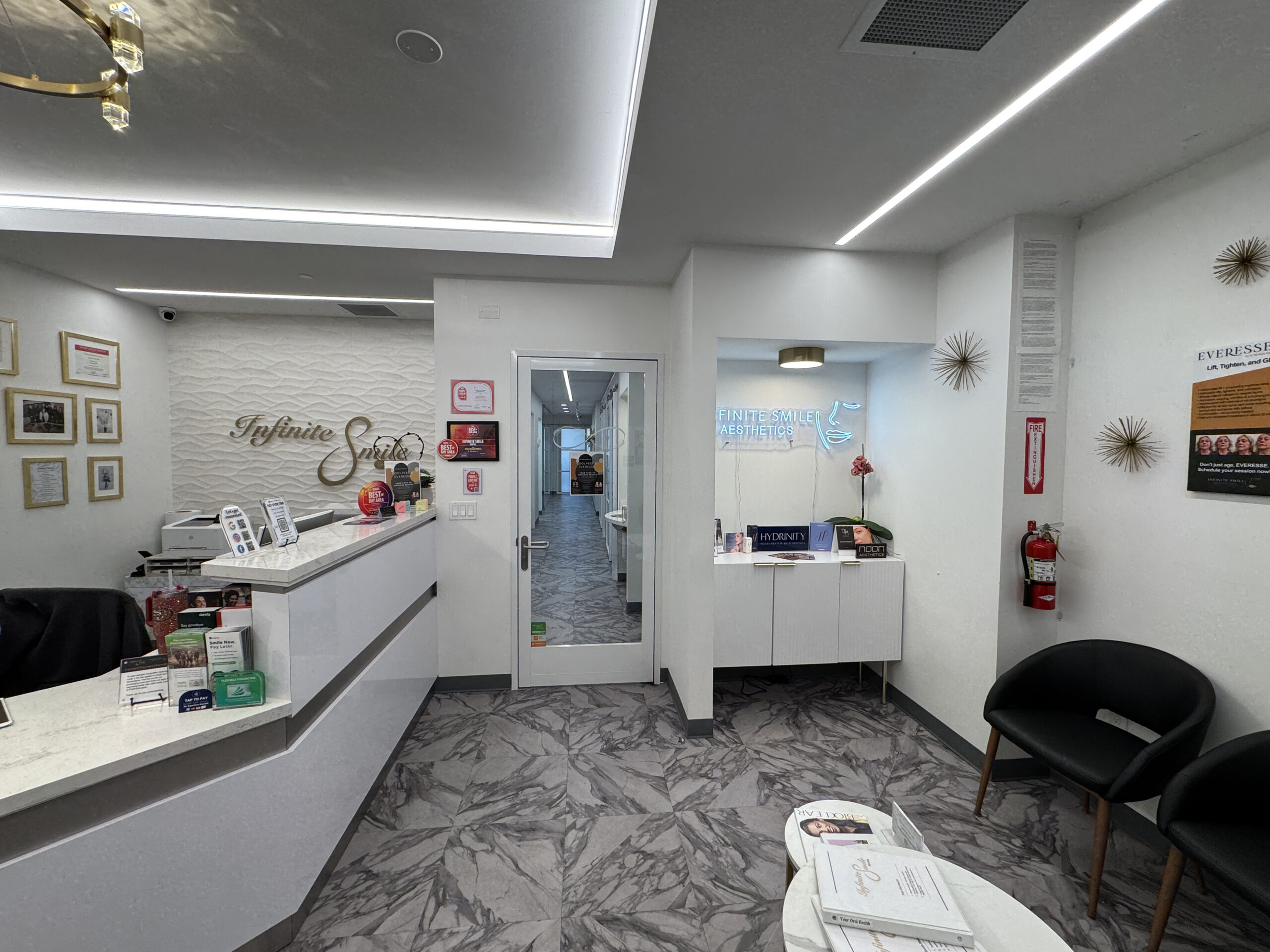 Bright and welcoming facial spa front desk area with adjacent comfortable waiting room seating