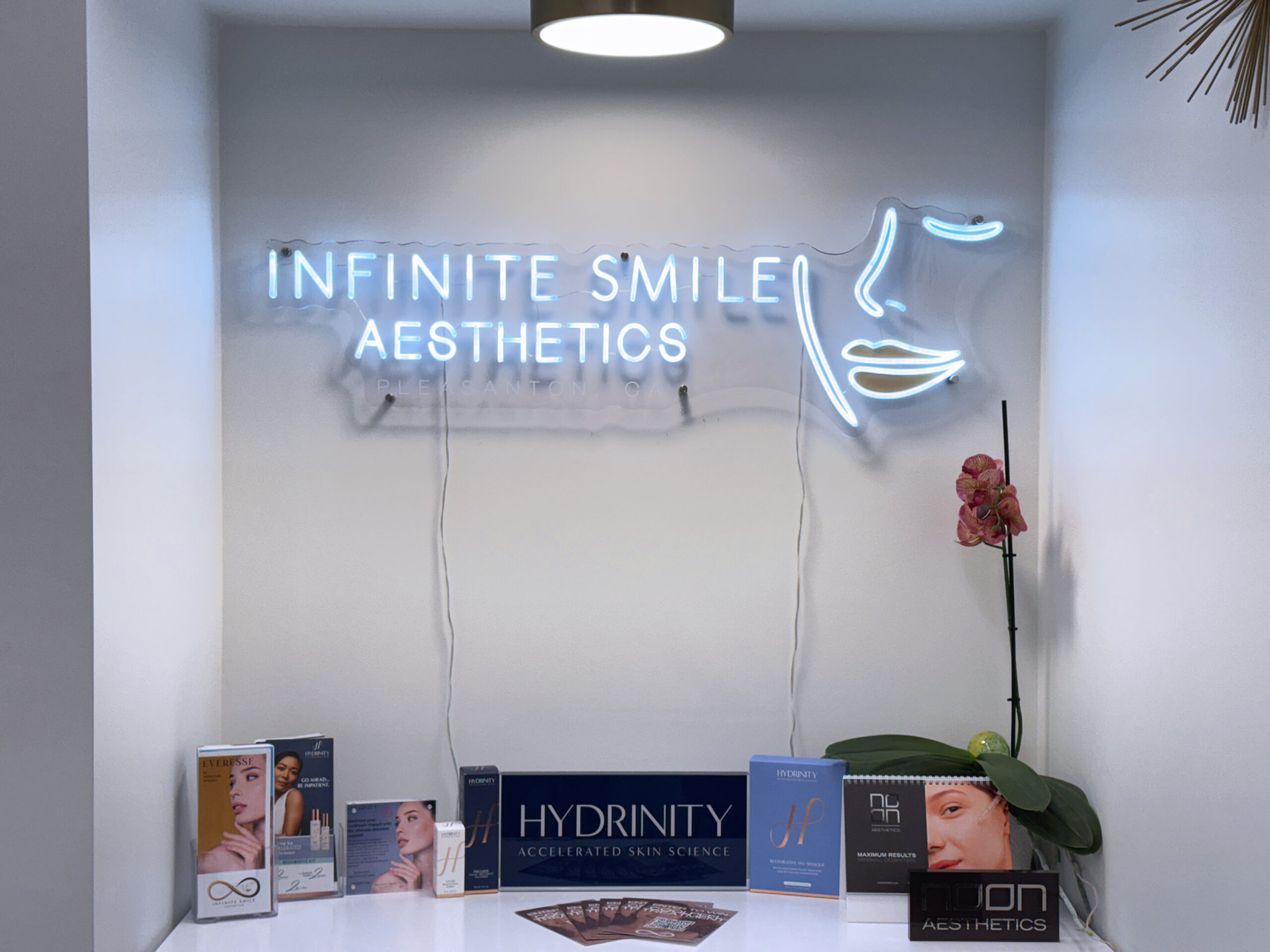 Vibrant neon sign glowing above a sleek display of premium skincare products at facial spa