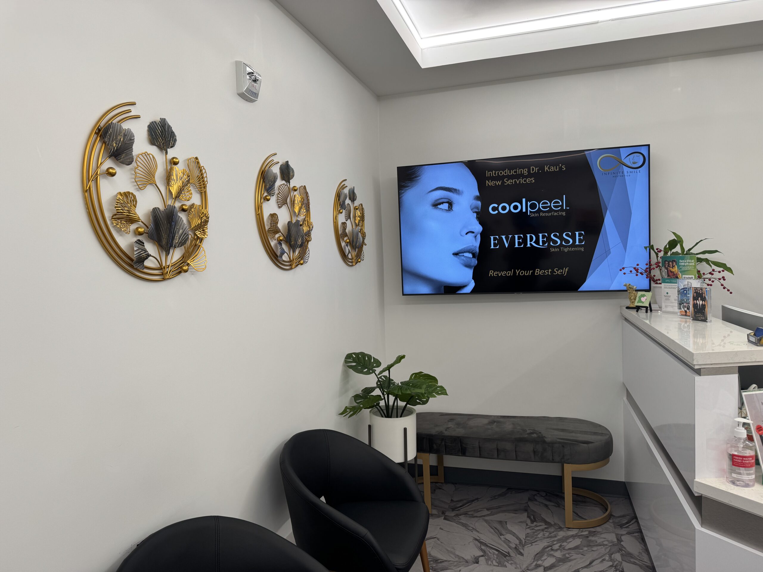 Modern and comfortable facial spa waiting room featuring a flat-screen TV and cozy seating