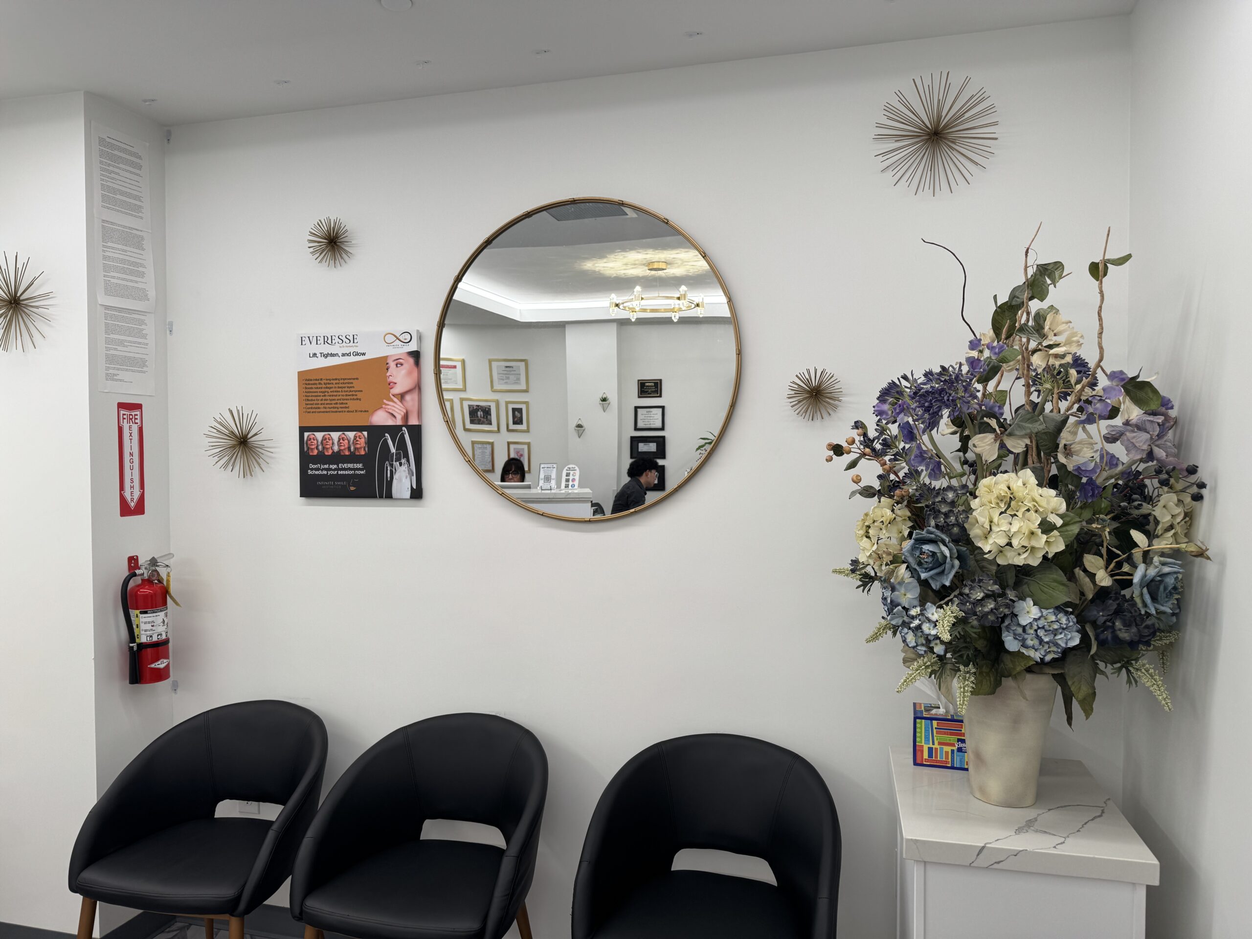 Elegant facial spa waiting room featuring comfortable chairs and a decorative wall mirror