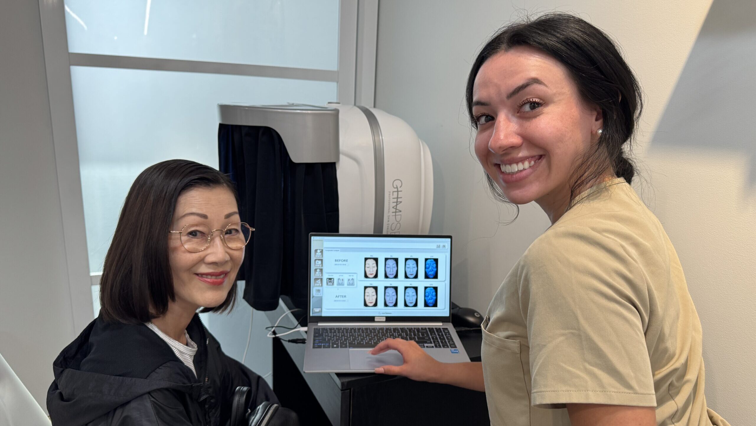 Facial spa professional reviewing Glimpse skin analysis results with patient on screen